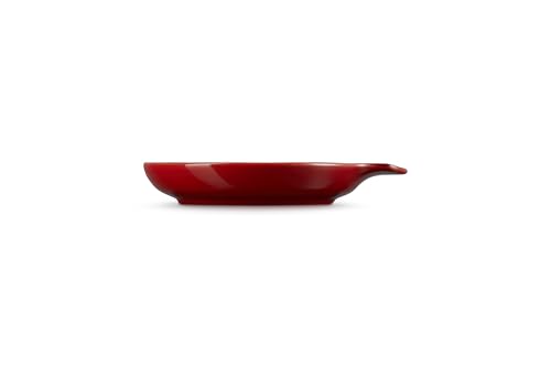 Le Creuset Signature Cerise stoneware spoon rest, 6 inches, with a smooth, curved design for holding cooking spoons.