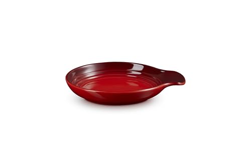 Le Creuset Cerise stoneware spoon rest, 6-inch size, with a smooth curved design for holding cooking spoons.