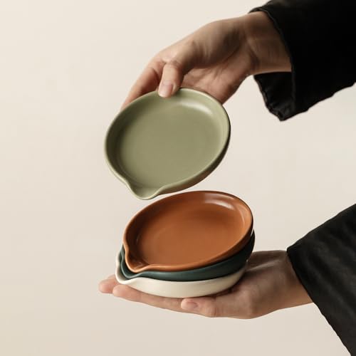 Set of four Vrutaoci ceramic spoon rests for holding spoons, spatulas, whisks, and ladles on stove tops.
