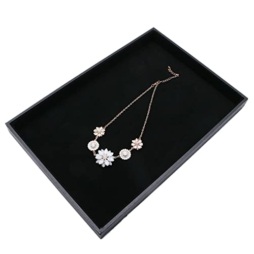 Two black velvet stackable jewelry trays with compartments for necklaces, bracelets, and rings, ideal for jewelry organization.