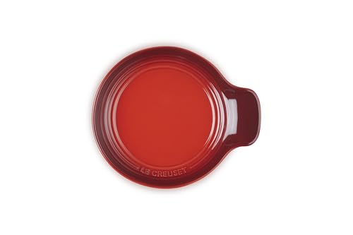 Le Creuset Cerise stoneware spoon rest, 6 inches, with curved design and glossy finish, ideal for kitchen countertop use.