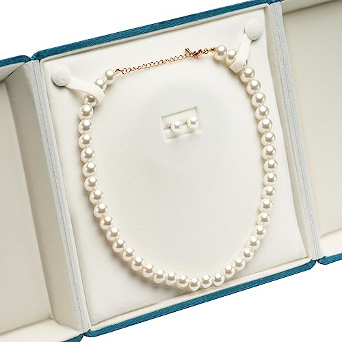 Blue jewelry storage case with velvet exterior holding a chunky pearl necklace and ring, ideal for gift presentation and organization.