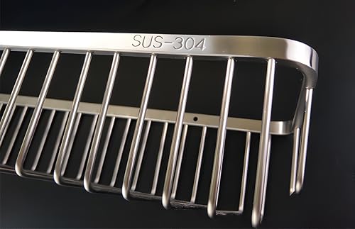 Nokozan stainless steel rectangular shower caddy holding shampoo bottles and body wash in a bathroom shower.