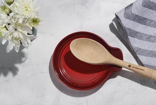 Le Creuset Signature 6-inch Cerise stoneware spoon rest with a smooth, curved design for holding cooking spoons and utensils.