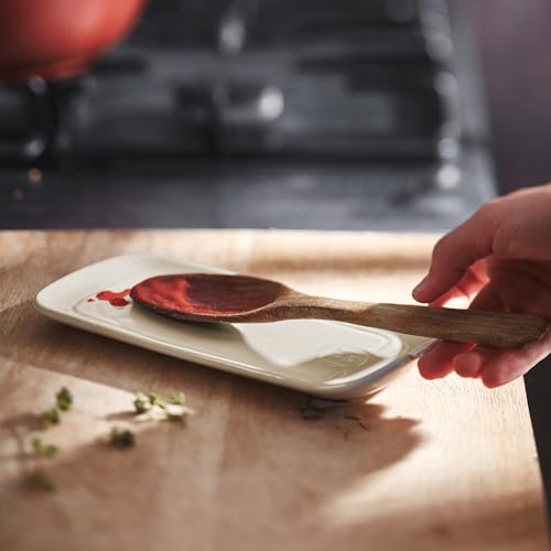Emile Henry ceramic spoon rest in clay, 9x4 inches, with a smooth, curved design for holding spoons on kitchen counters.
