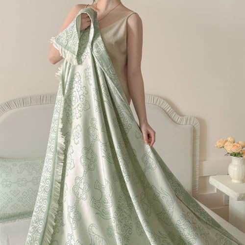 Twin sage green cotton boho reversible throw blanket by CinYana, showing its soft, patterned fabric and cozy design.