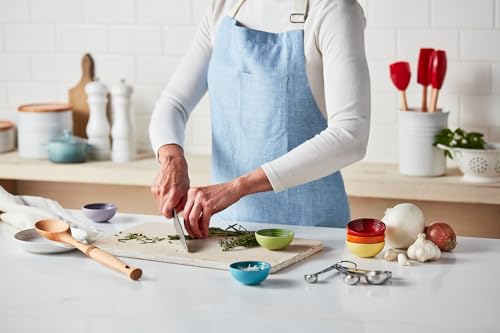 Le Creuset Signature Cerise stoneware spoon rest, 6-inch size, with a smooth, curved design for holding cooking utensils.