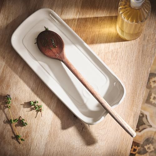 Emile Henry ceramic spoon rest in clay, 9x4 inches, featuring a smooth, rounded design for holding cooking spoons.