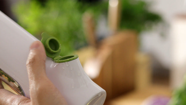 Clear Prepara Herb Savor food jar for fresh herbs, featuring a compact canister design perfect for storing herbs and spices.
