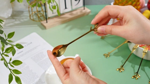 Set of 40 gold stainless steel leaf-shaped coffee and dessert spoons and appetizer forks by Honeydak, stylish and functional.