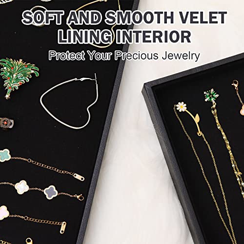 Two black velvet stackable jewelry trays with compartments for necklaces, bracelets, and rings, ideal for jewelry organization.