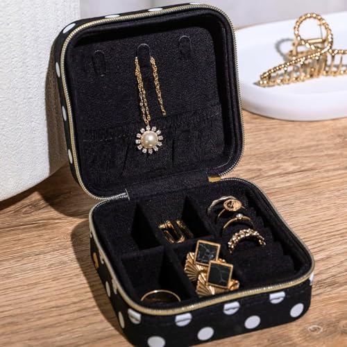 Kate Spade New York polka dot travel jewelry case with compartments for organizing necklaces, rings, and earrings.