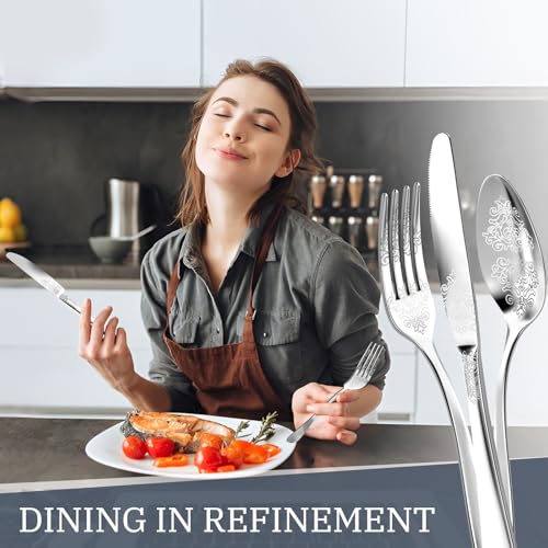 DRAGON RIOT 20-piece stainless steel flatware set for four, includes forks, knives, spoons, and serving utensils in a silver finish.