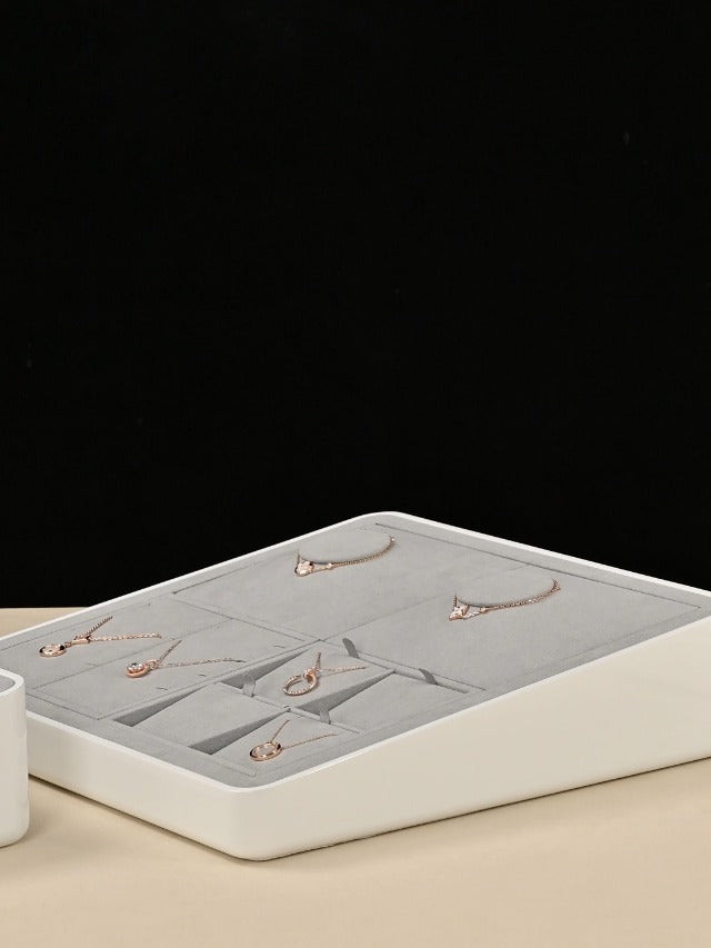 Grey microfiber jewelry necklace display tray by Oirlv with multiple compartments for organizing necklaces and jewelry pieces.