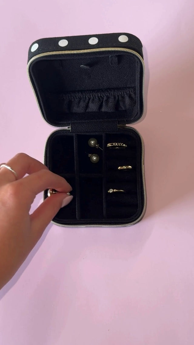 Kate Spade New York polka dot travel jewelry case with compartments for organizing rings, necklaces, and earrings.