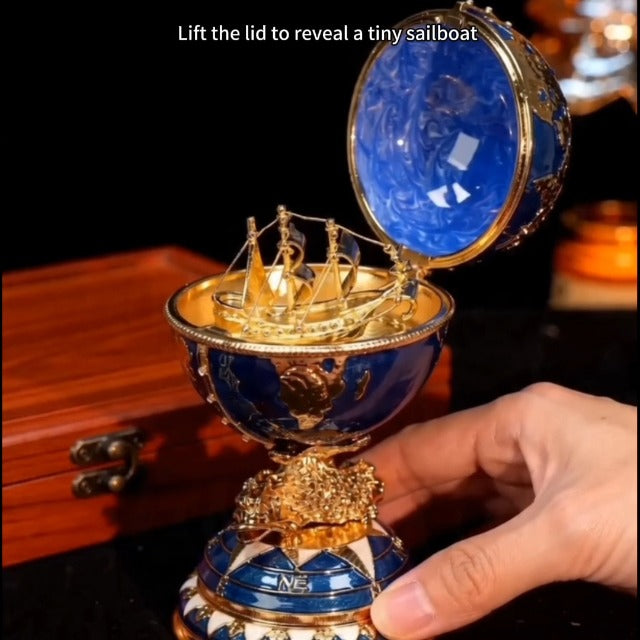 Blue and gold enameled decorative globe jewelry box with world map design, ideal for storing trinkets and jewelry.