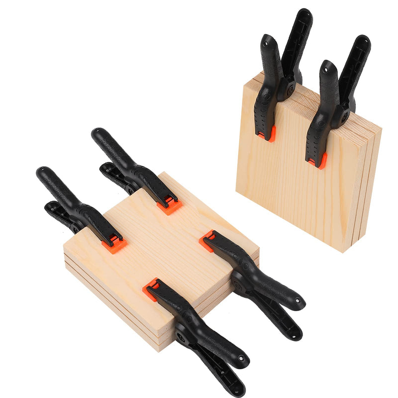 Eight black Romeda spring clamps, 4.5-inch plastic clips for crafts, photography backdrops, woodworking, and studio use.